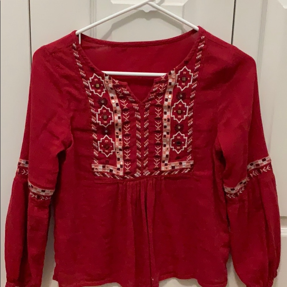 Red blouse with a tribal print embroidery